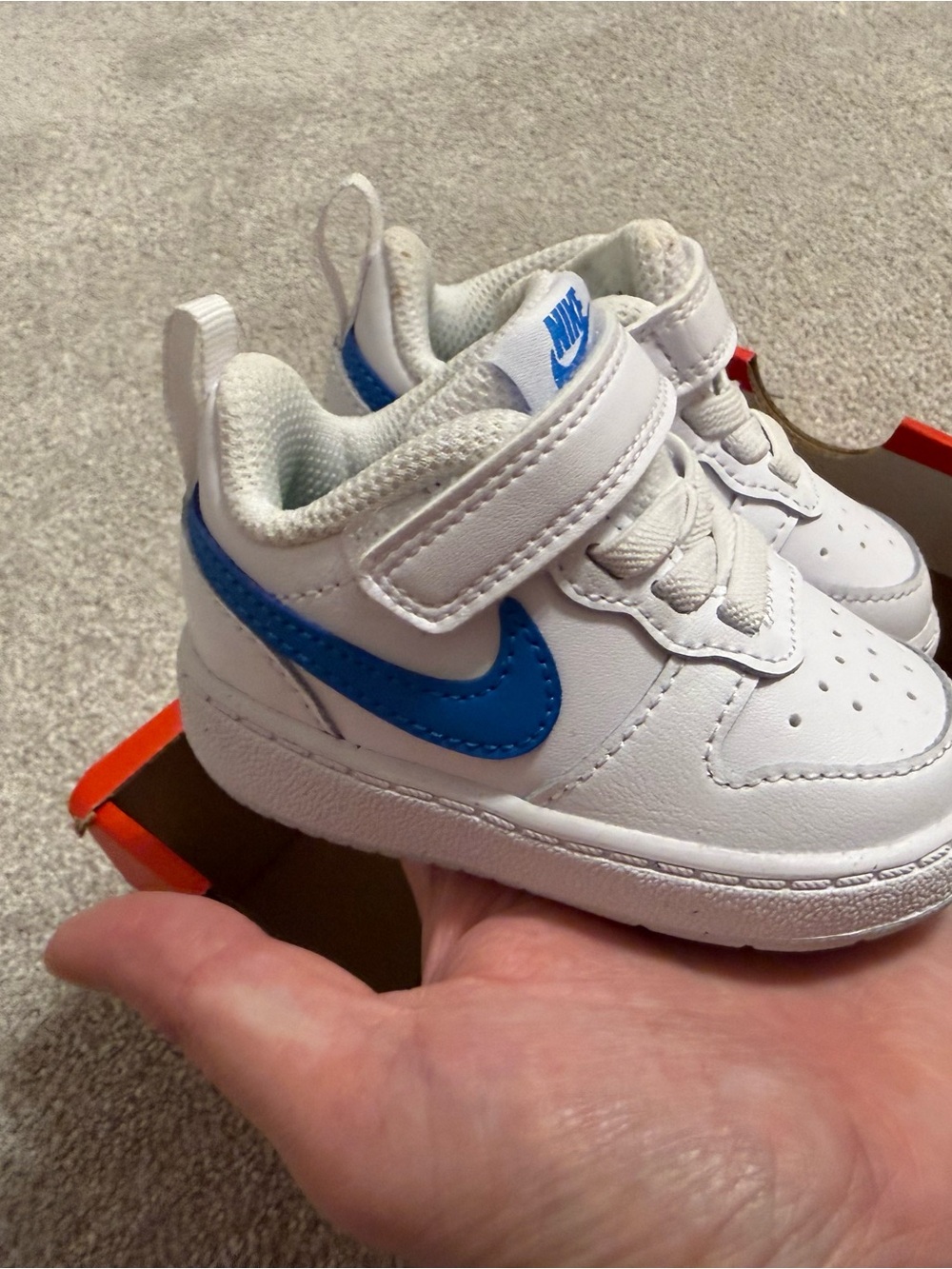 Nike Toddler White Sneaker with Blue Swoosh